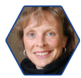 Porträtfoto einer erwachsenen Person in sechseckigem Rahmen.